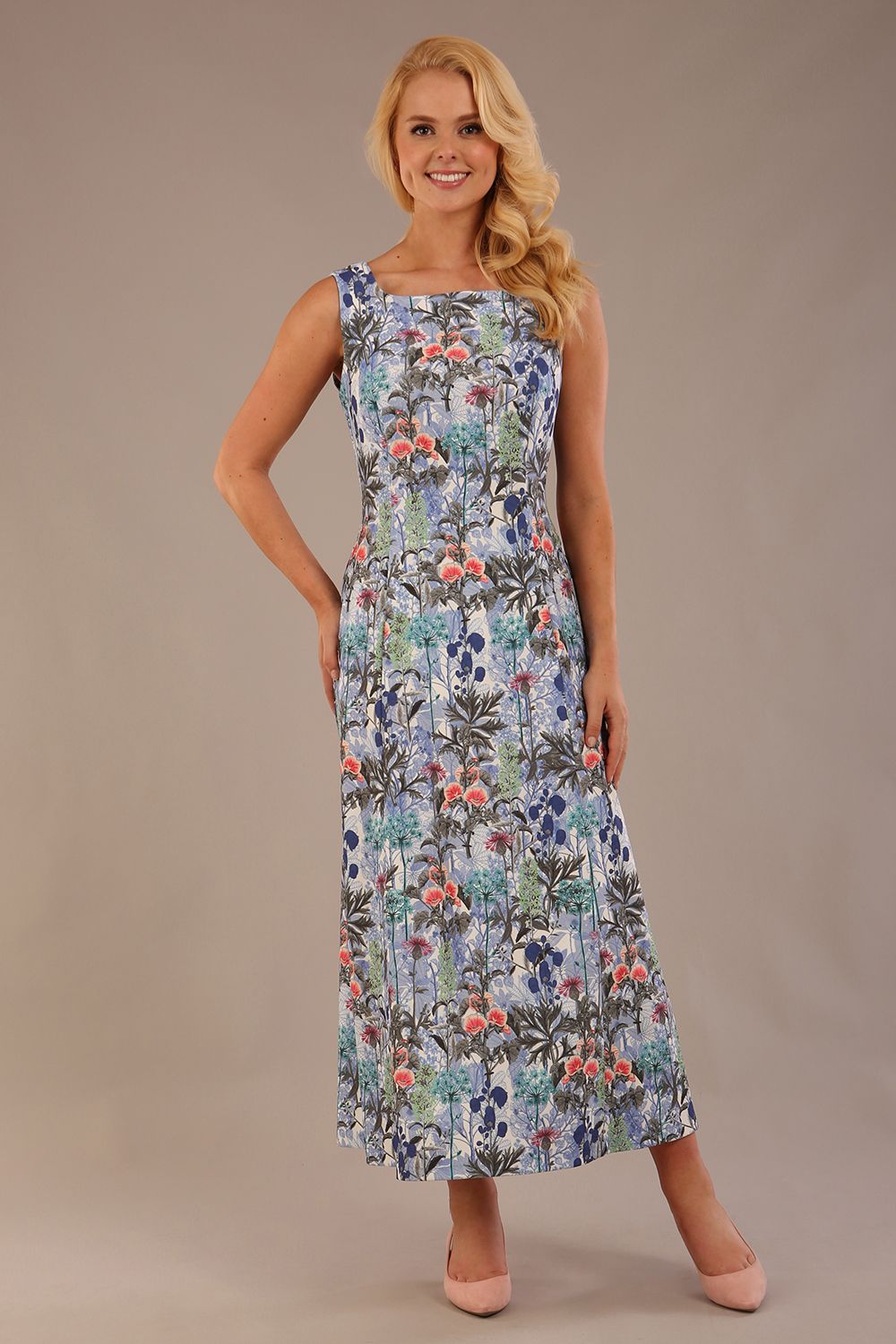 blonde model is wearing a 7000 diva catwalk Glyndebourne Sleeveless Square Neck Maxi Dress in Water Garden print with pockets front