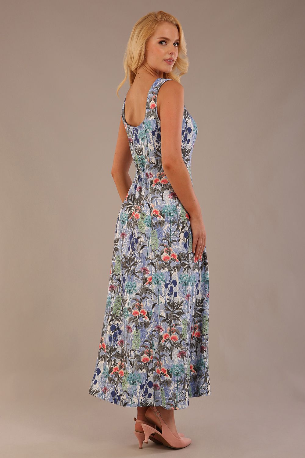 blonde model is wearing a 7000 diva catwalk Glyndebourne Sleeveless Square Neck Maxi Dress in Water Garden print with pockets back