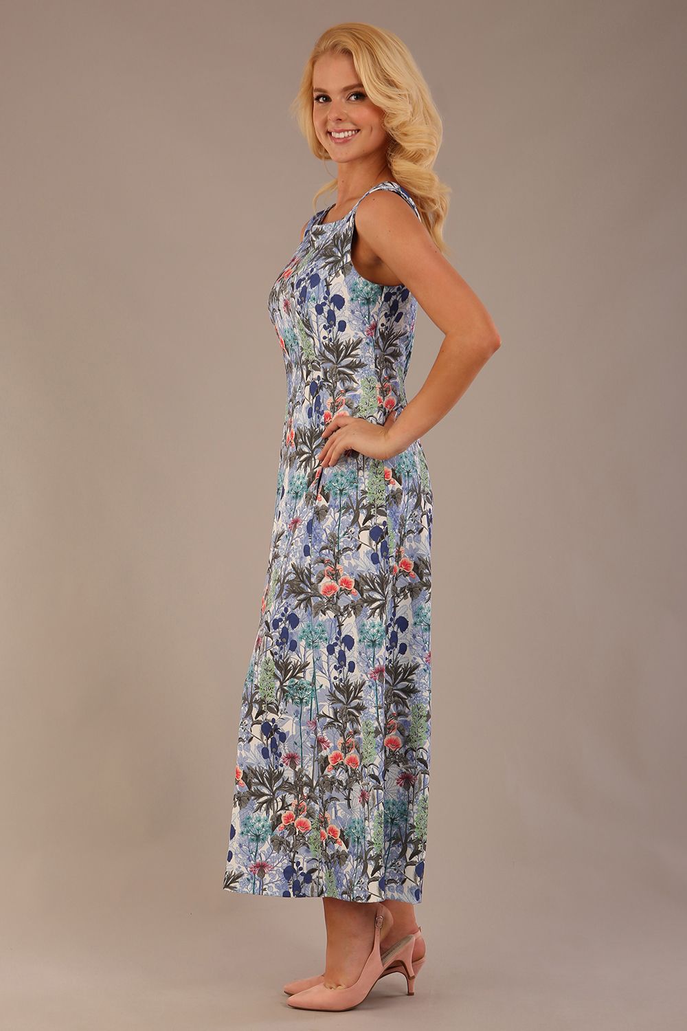 blonde model is wearing a 7000 diva catwalk Glyndebourne Sleeveless Square Neck Maxi Dress in Water Garden print with pockets front