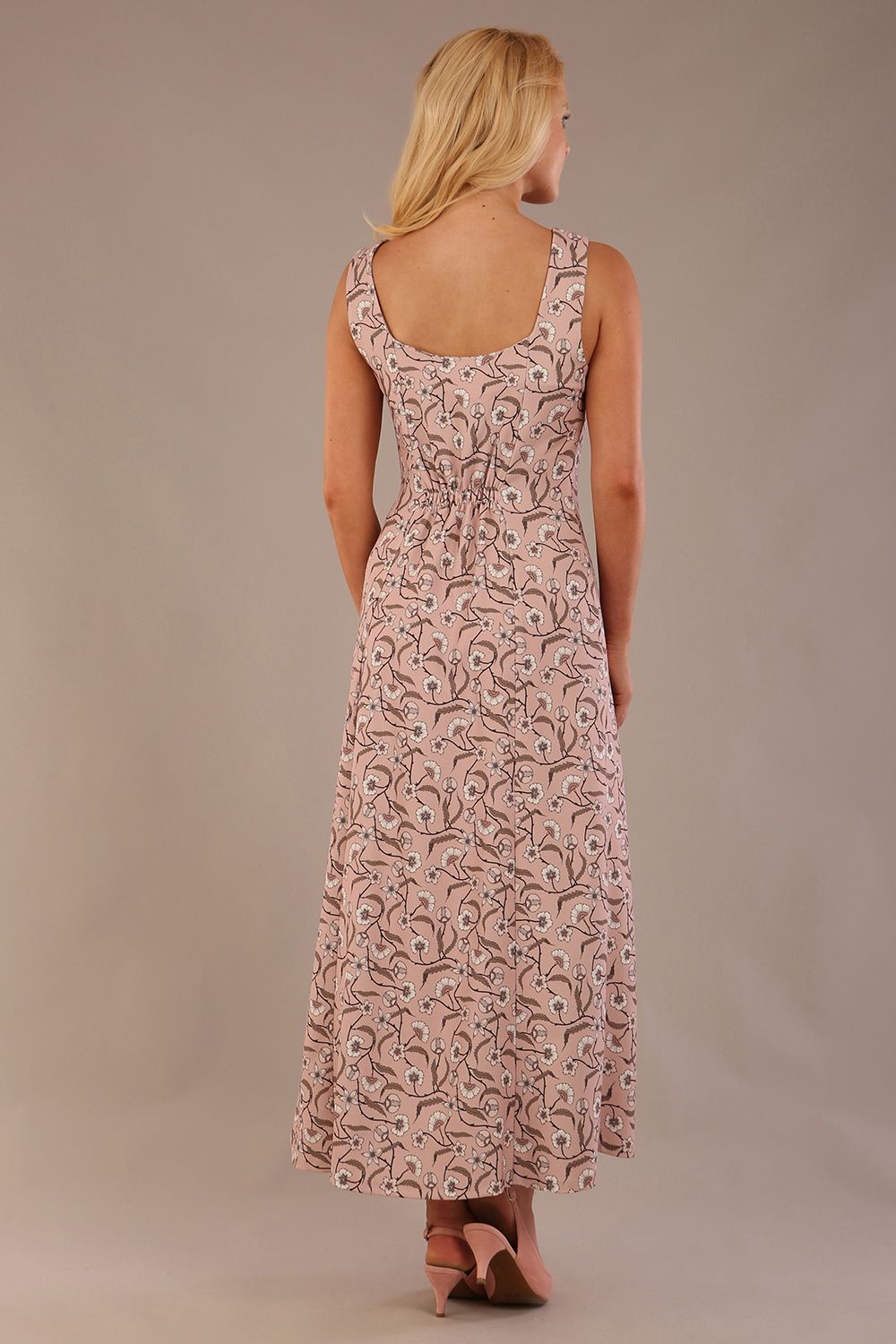 blonde model is wearing a 7000 diva catwalk Glyndebourne Sleeveless Square Neck Maxi Dress in tudor vine print with pockets back