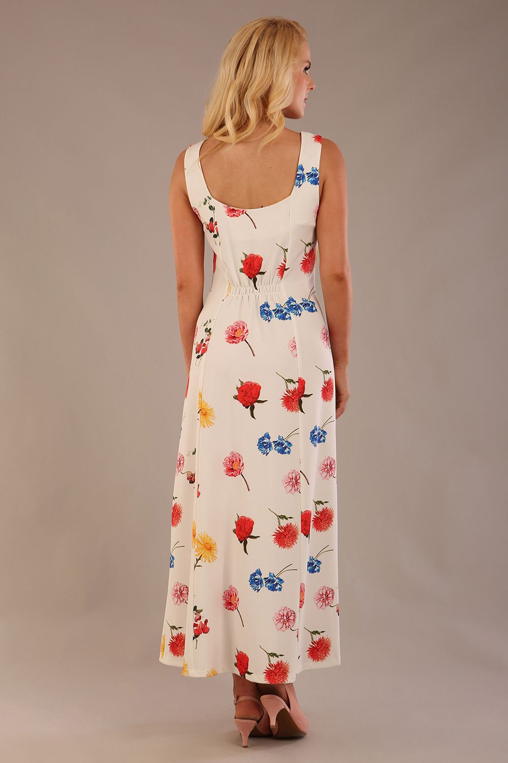 blonde model is wearing a 7000 diva catwalk Glyndebourne Sleeveless Square Neck Maxi Dress in buttercup print with pockets back