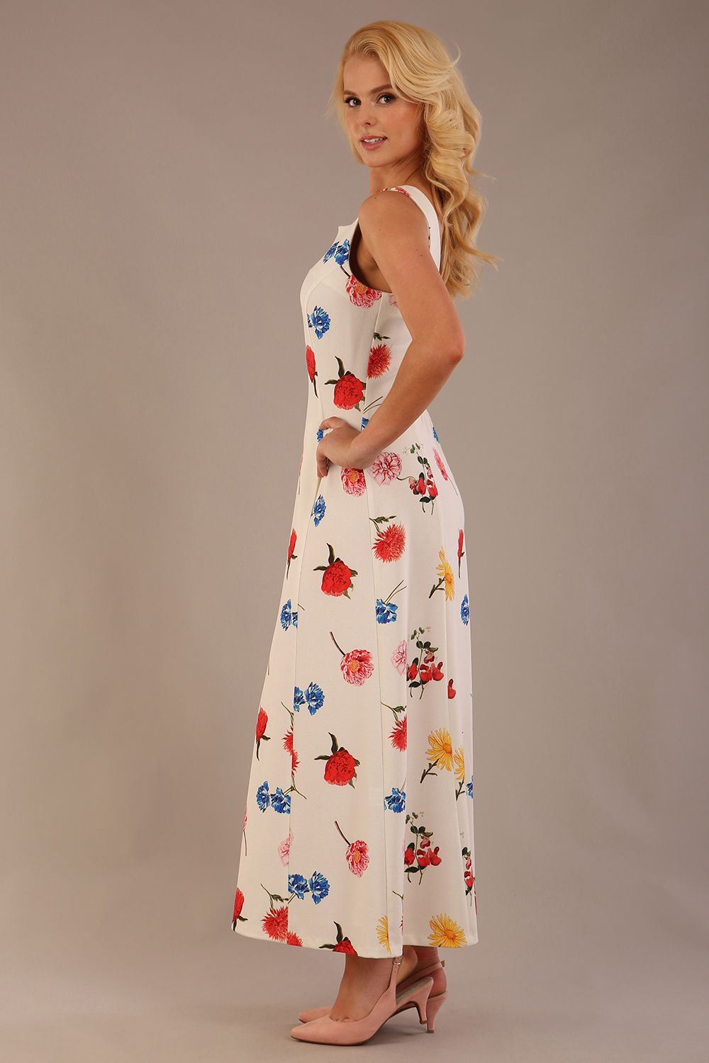 blonde model is wearing a 7000 diva catwalk Glyndebourne Sleeveless Square Neck Maxi Dress in buttercup print with pockets side