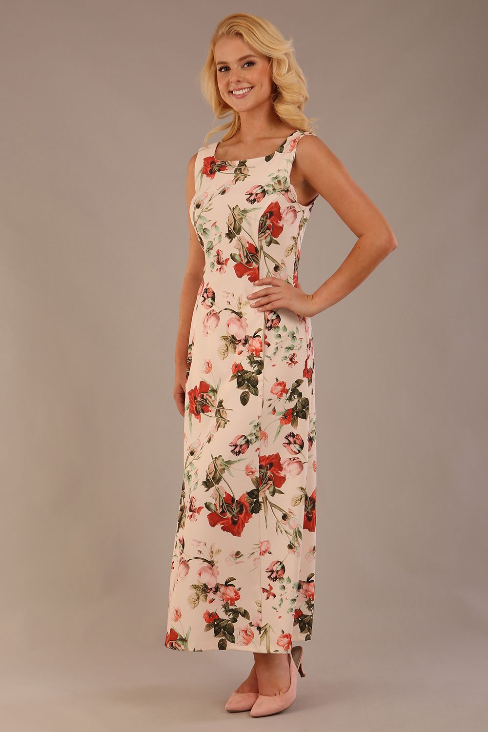 blonde model is wearing a 7000 diva catwalk Glyndebourne Sleeveless Square Neck Maxi Dress in Rose Blush print with pockets front