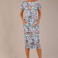 brunette model is wearing a 7002 diva catwalk Carlisle Boat Neck Short Sleeve Midi Pencil Dress in water garden print with side pockets front
