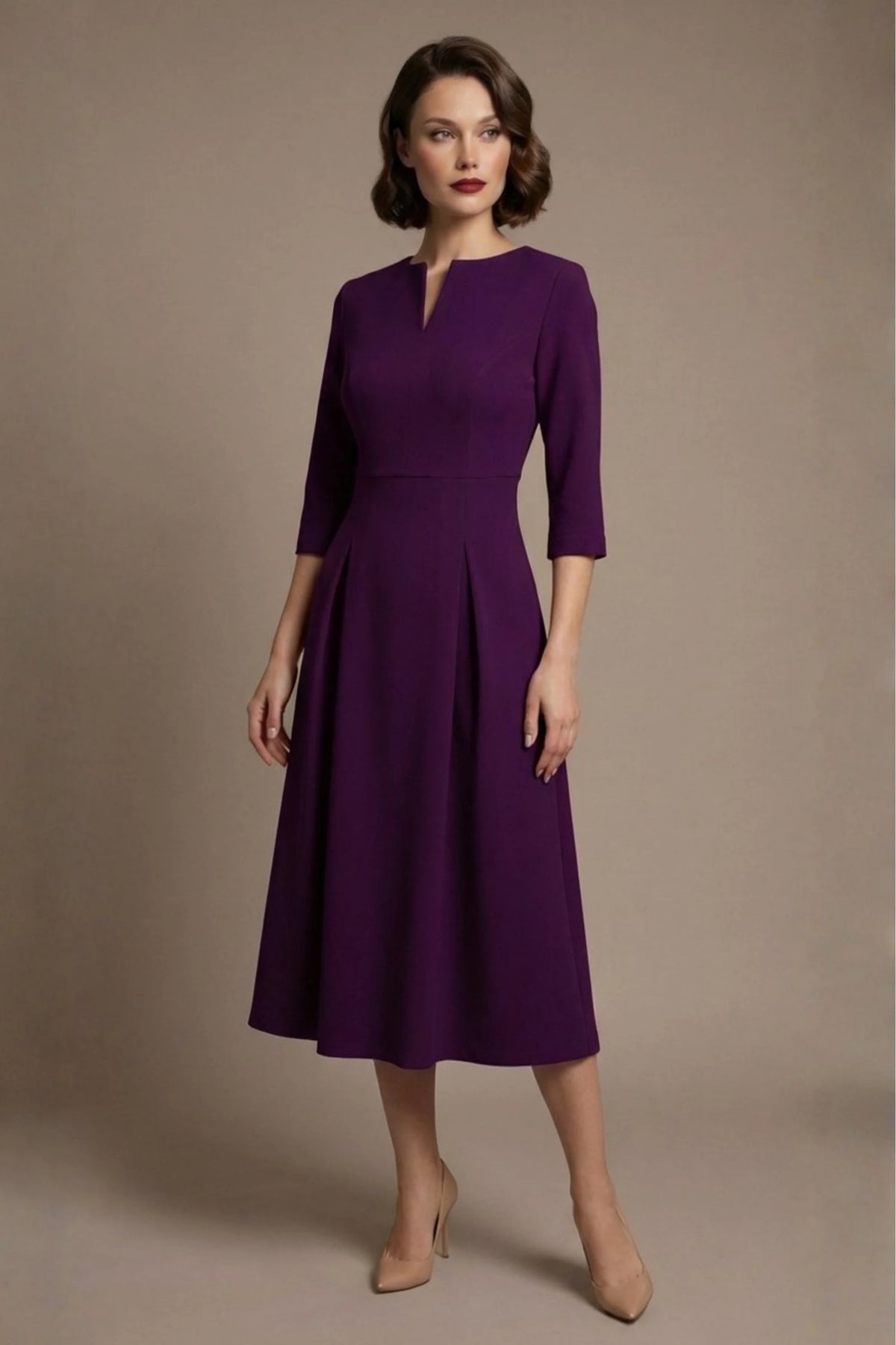 Woman wearing a diva catwalk Amanda Pleated a-line dress in a magenta pink colour against a beige background (Purple)