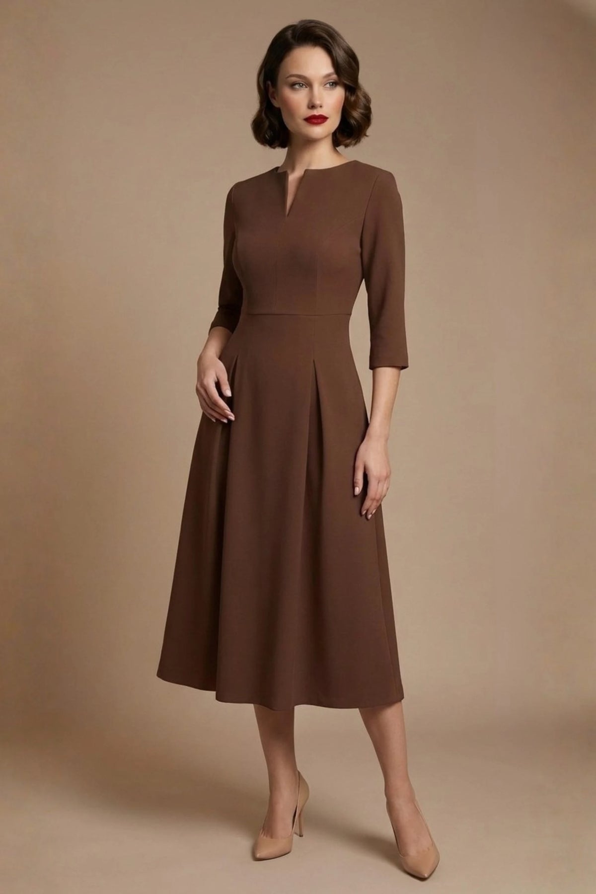 Woman wearing a diva catwalk Amanda Pleated a-line dress in a magenta pink colour against a beige background (Peppercorn Brown)