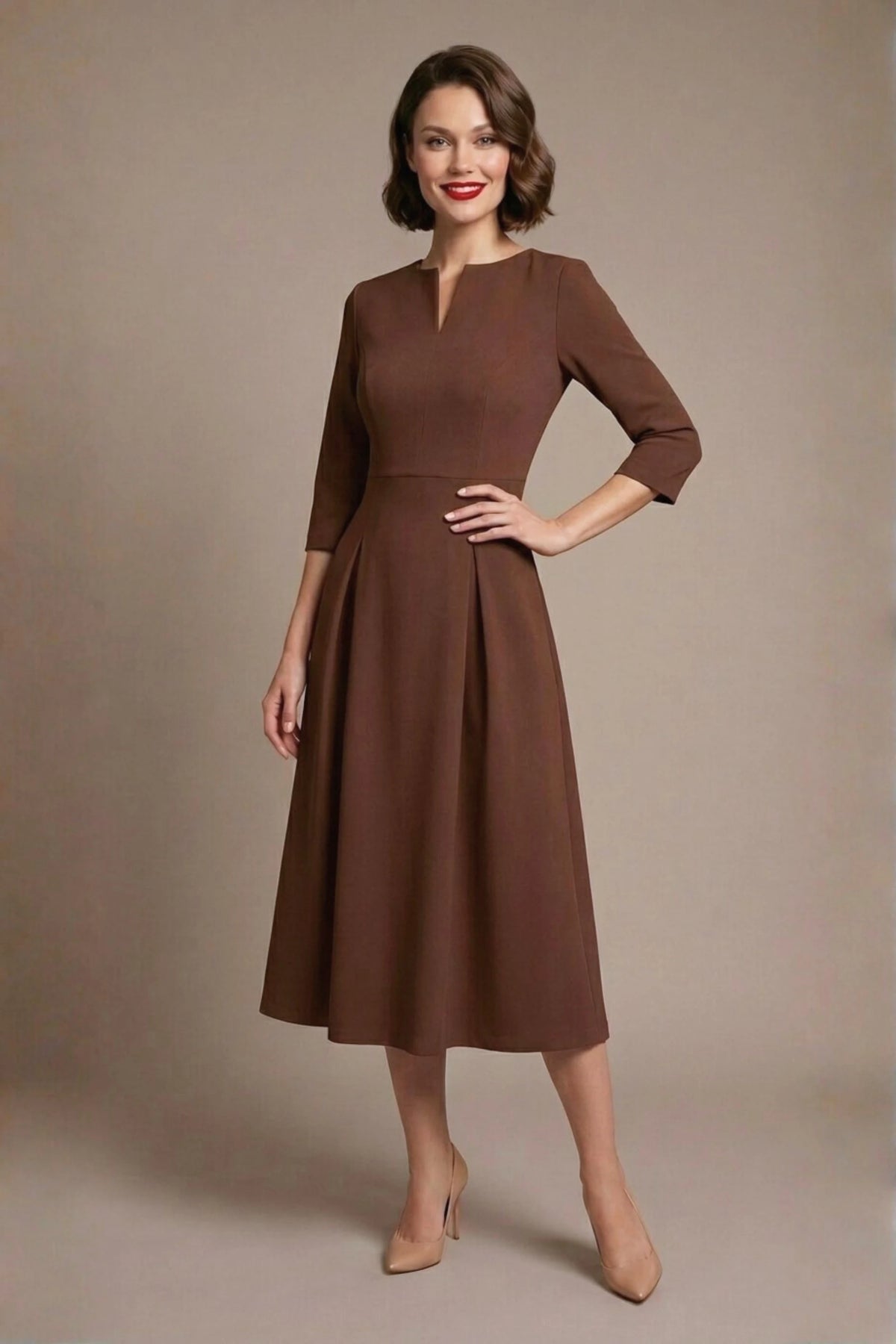 Woman wearing a diva catwalk Amanda Pleated a-line dress in a magenta pink colour against a beige background (Peppercorn Brown)