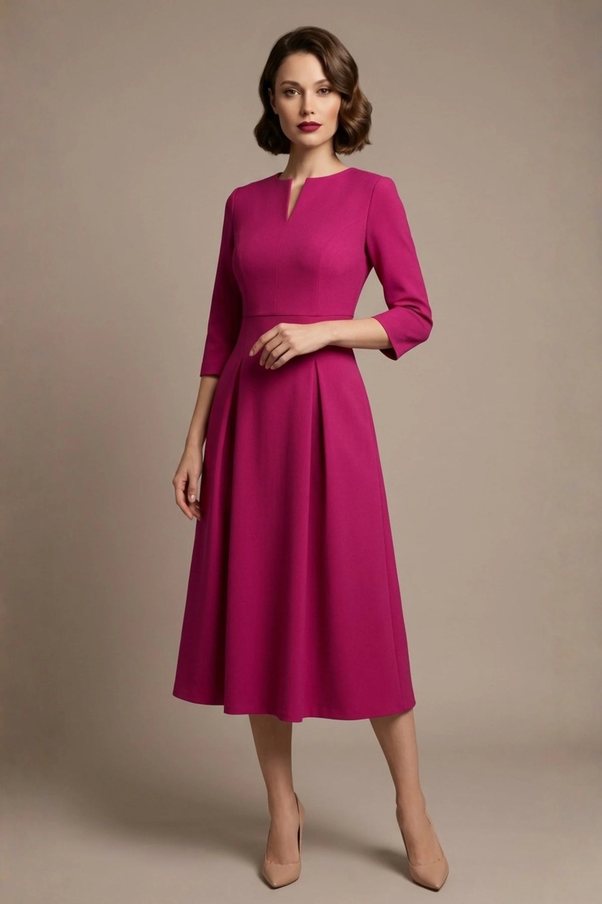 Woman wearing a diva catwalk Amanda Pleated a-line dress in a magenta pink colour against a beige background (Magenta)