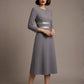 model wearing the Seed Alisa dress, showcasing the sharp V-notch neckline, flawless tailoring, and luxurious satin contrast detail (Sky Grey - Silver Grey)