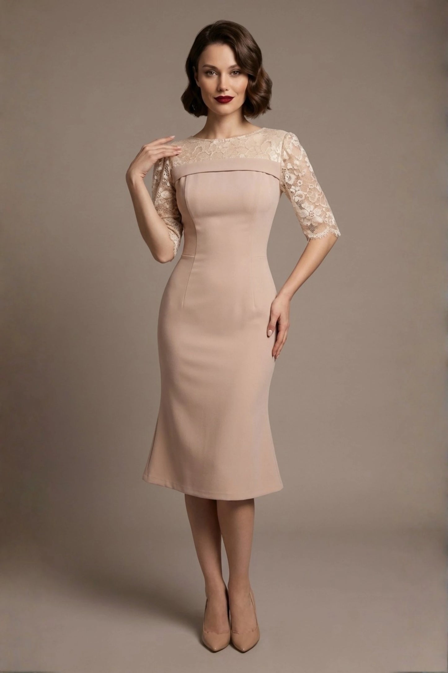 Woman wearing a diva catwalk Francesca Lace Fluted Dress in pink haze colour dress with lace sleeves against a brown background (Pink Haze)