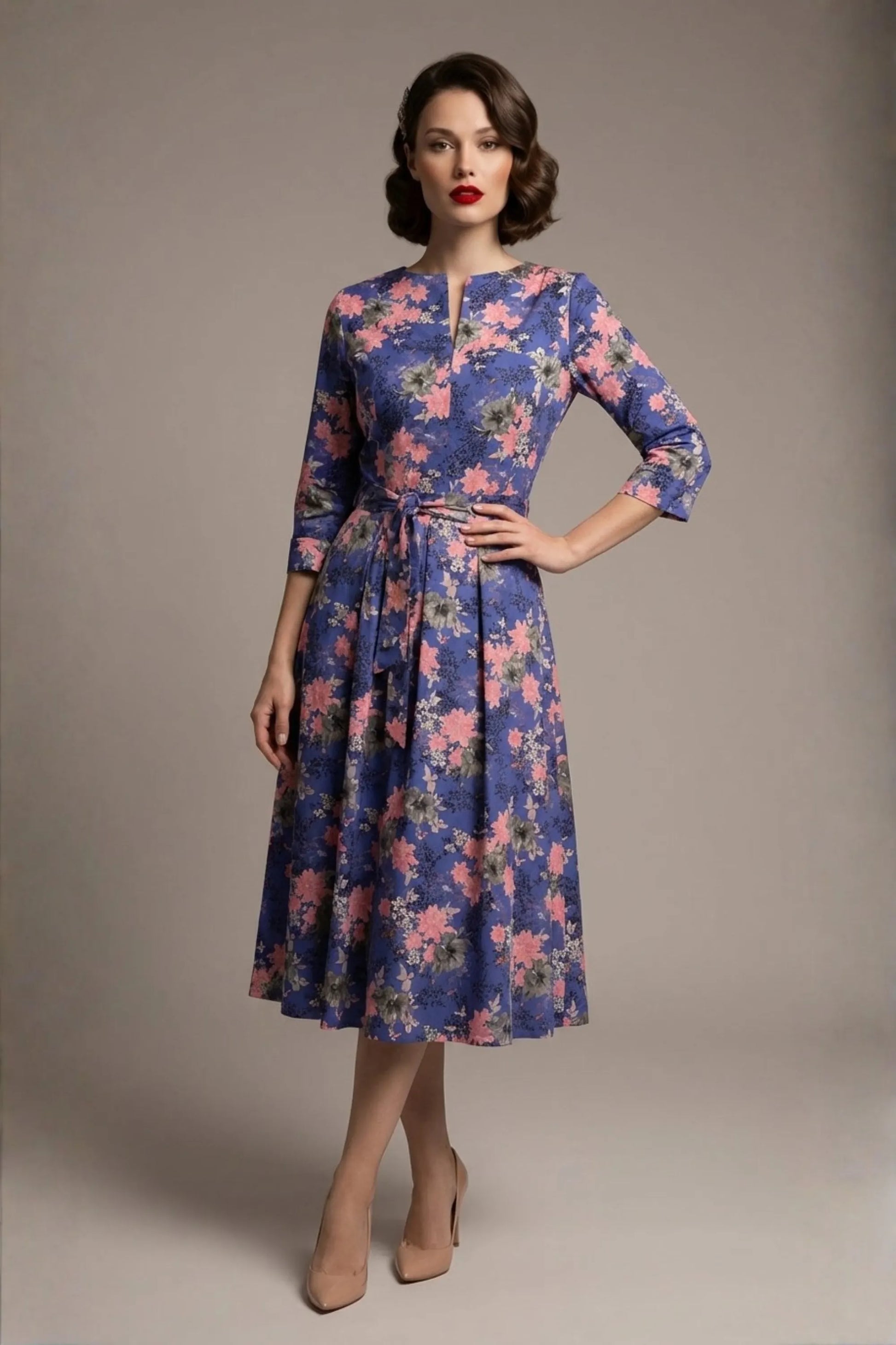 A model showcasing the vintage-inspired Zuleika floral midi dress, styled with retro accessories, highlighting the cinched tie-waist and V-notch neckline (Chelsea Garden Bloom Print)
