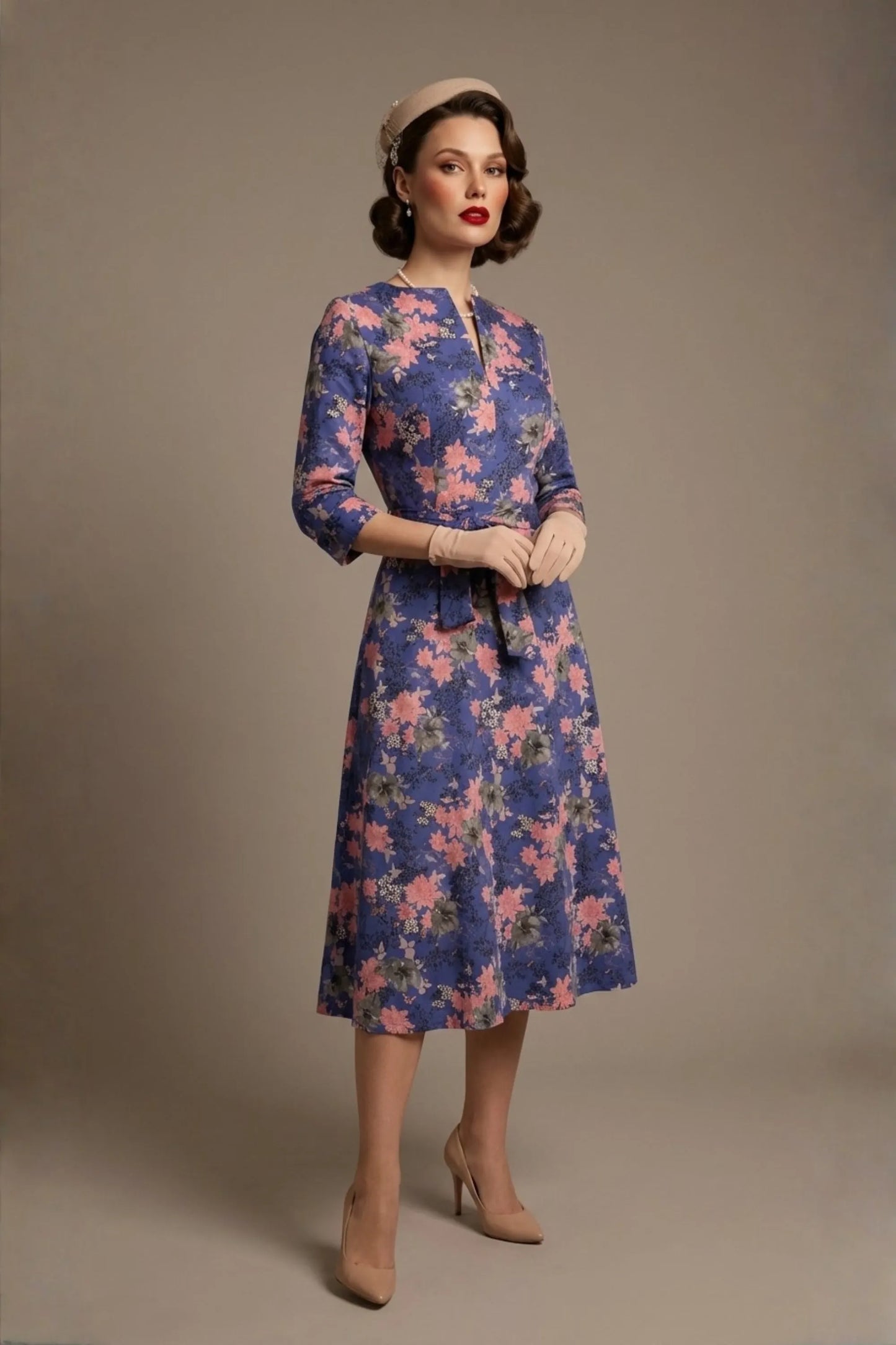 A model showcasing the vintage-inspired Zuleika floral midi dress, styled with retro accessories, highlighting the cinched tie-waist and V-notch neckline (Chelsea Garden Bloom Print)