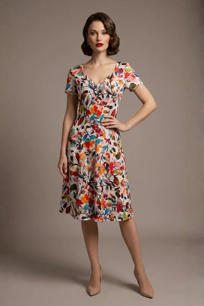 Woman wearing a diva catwalk colorful floral dress called Valia Silk Touch A-Line Dress against a plain background (Erratic Leaf Print)