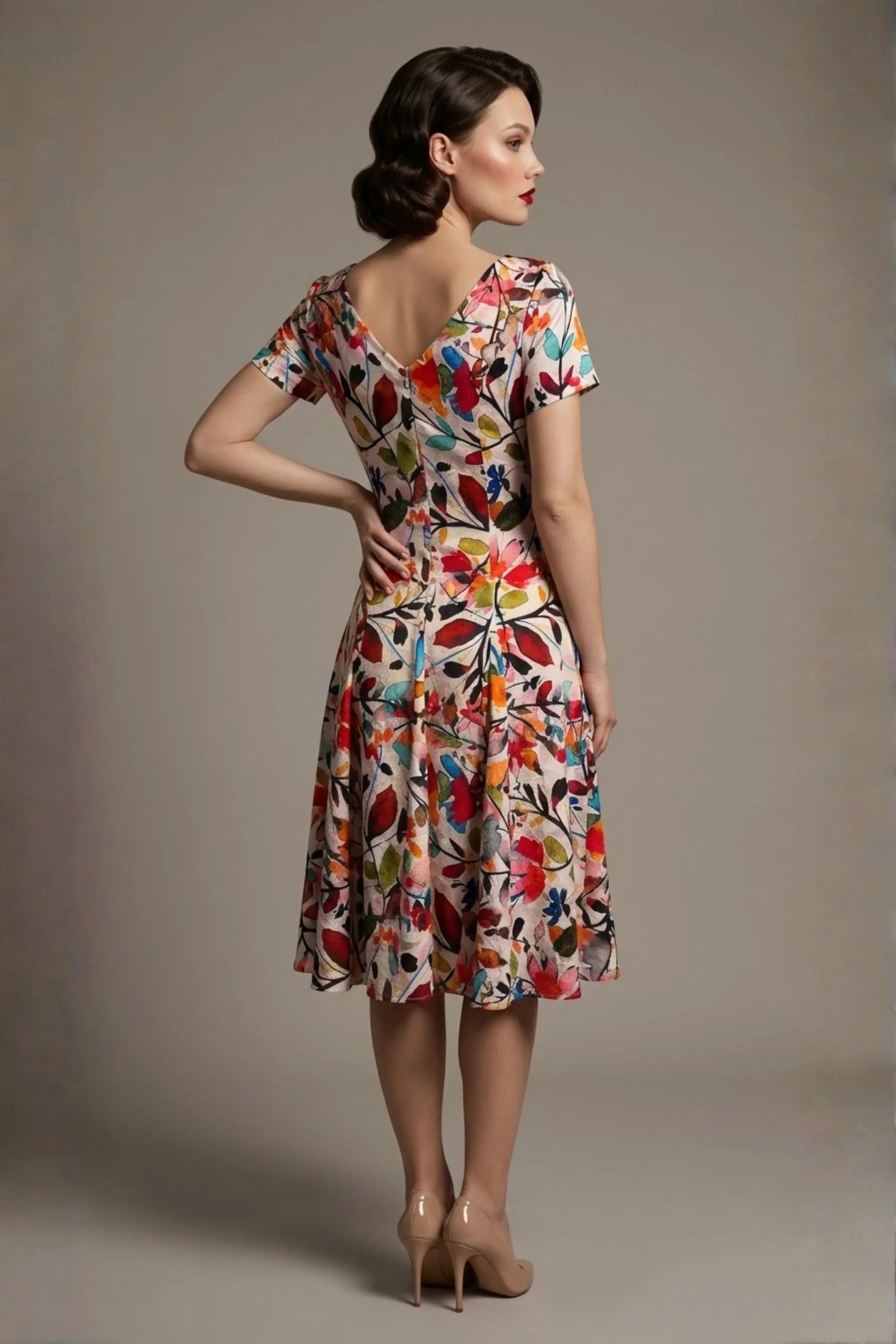 Woman wearing a diva catwalk colorful floral dress called Valia Silk Touch A-Line Dress against a plain background (Erratic Leaf Print)
