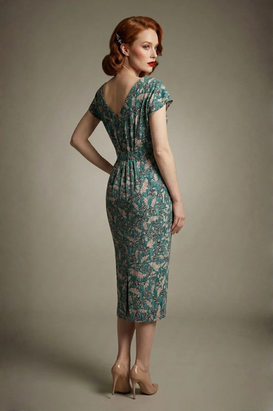 Woman wearing a diva catwalk Magritte Vintage Floral Cotton Pencil Dress, floral dress against a plain background (Vintage Floral Print)