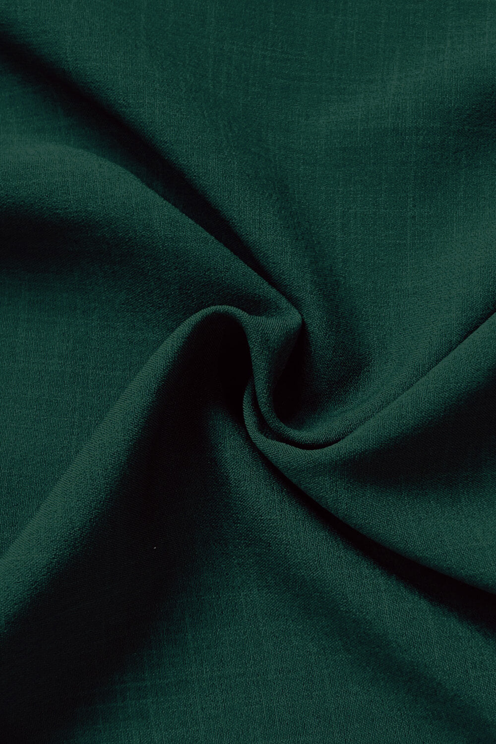 Close-up of dark green fabric with folds